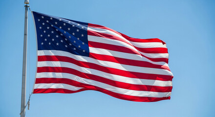Fototapeta premium A vibrant American flag proudly waves against a clear blue sky, symbolizing freedom, patriotism, and national pride. Perfect for Fourth of July, Memorial Day, election season, or any representation