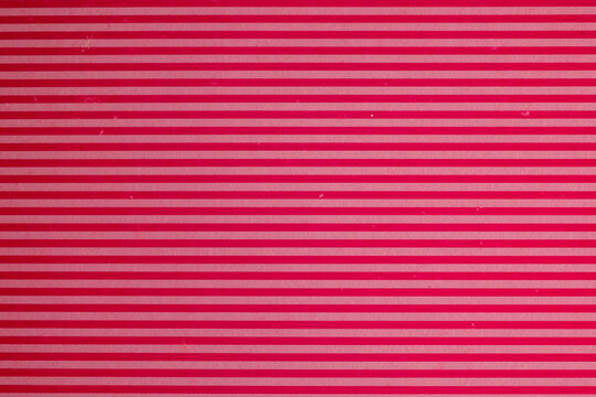 Horizontal red and pink striped paper background

