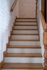 A wooden staircase with a railing will lead to the top