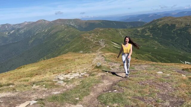 A Woman Walking on a Beautiful Mountain Trail and enjoying nature