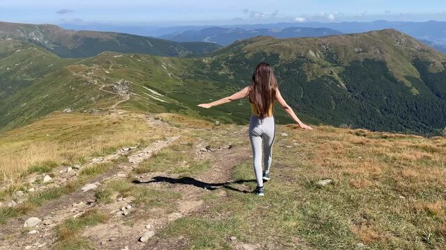A Woman Walking on a Beautiful Mountain Trail and enjoying nature