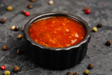 juicy golden grilled barbecue meat with spices on dark background