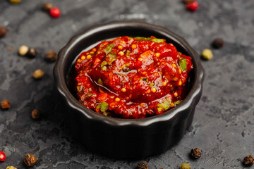 juicy golden grilled barbecue meat with spices on dark background