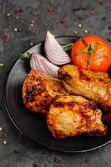 juicy golden grilled barbecue meat with spices on dark background
