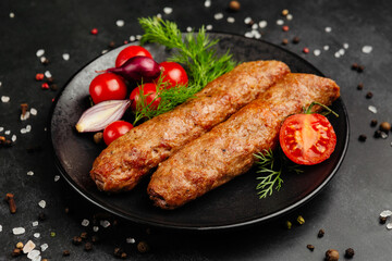 juicy golden grilled barbecue meat with spices on dark background