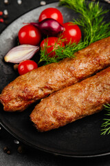 juicy golden grilled barbecue meat with spices on dark background