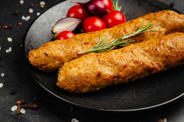 juicy golden grilled barbecue meat with spices on dark background