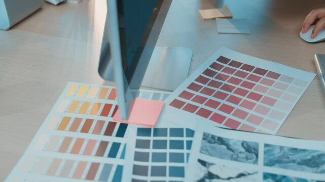 A vibrant workspace featuring a color palette, modern metallic object, and a coffee mug. Perfect for illustrating creativity, design process, and innovative projects. SACTR