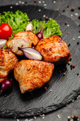 juicy golden grilled barbecue meat with spices on dark background