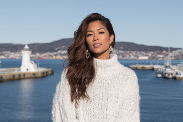 woman in white sweater gazes intensely her expression captivating