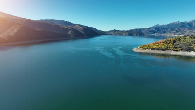 Aerial of the Palisades Reservoir on the Snake River in Idaho. Leaves are turning their fall colors.