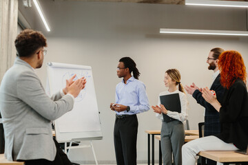 Business team applauding speaker after successful presentation