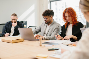 Business people working together in modern office using laptop and documents
