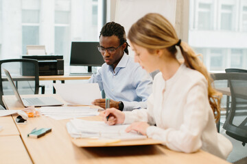 Business people working together in modern office analyzing documents