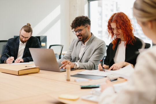Diverse team collaborating in modern office setting