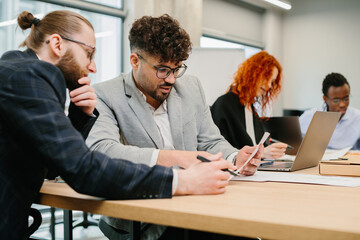 Business people working together in modern office analyzing documents