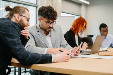 Business people working together in modern office analyzing documents