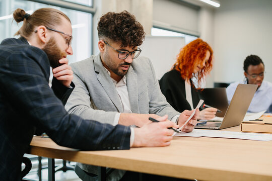 Business people working together in modern office analyzing documents