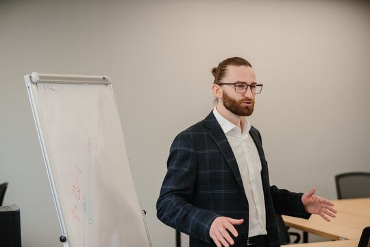 Businessman giving presentation using whiteboard in meeting room
