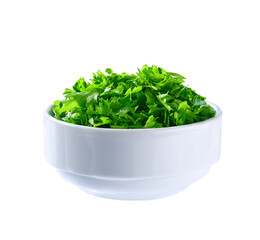 Chopped parsley in a ceramic bowl isolated on white background. Clipping path.