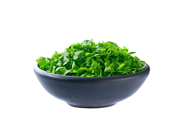 Fototapeta premium Chopped parsley in a black ceramic bowl isolated on white background.