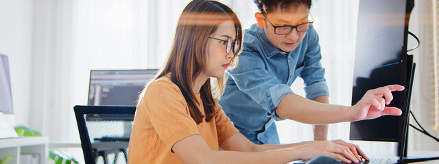 Asian male, female programming developer work together at home office, brainstorm discussion. Information technology, software engineer programmer coding job, man woman coworker teamwork. Copy space