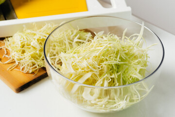 slicing cabbage with a shredder