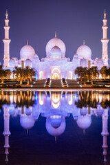 Perfect reflection on the water of the Sheikh Zayed Grand Mosque of Abu Dhabi at night,  UAE