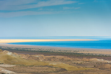 Layers of desert,  salt marsh and water of the Aral Lake, Uzbekistan