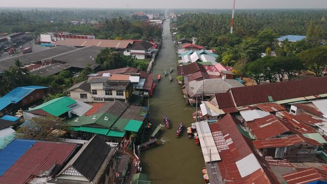 Longtail boats sailing on canals of Damnoen Saduak Floating Market, Aerial View, Thailand, Bangkok.