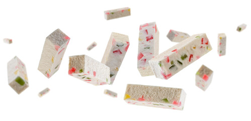 Sticks of marshmallow with colorful pieces of candied fruits fly and levitate in space. Isolated on white