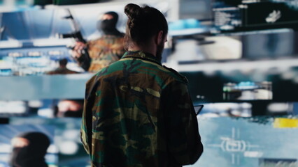 Armed forces officer monitoring drone and satellite imagery to gather intelligence, collecting insight for war planning. Mission control and secure global operations through cyber defense. Camera A.