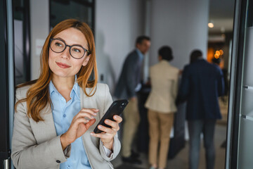 Confident smile adult businesswoman use mobile phone on break