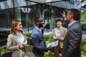 black businessman hold clipboard explain details to diverse colleagues