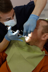 Dentist administering anesthesia to a patient in a dental clinic.