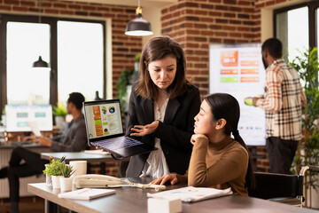 Professional marketer using the internet to display advertising strategies, analyzing client data...