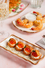 a luxurious dinner in a restaurant with seafood in delicate pink tones