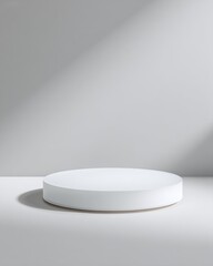 Minimalistic frosted glass podium with soft gray backdrop ideal for elegant product displays in modern settings