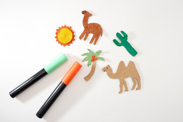 Colorful paper elements for desert diorama on white background, ideal for craft supply stores, educational publishers, DIY kits, art teachers, creative children learning materials,