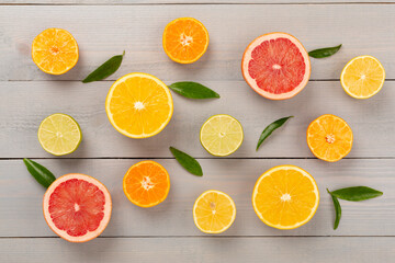 Different citrus fruits on wooden background, top view