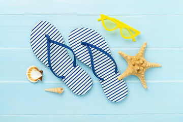 Striped blue flip flops on wooden background, top view