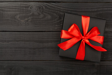 Black gift boxes on wooden background, top view. Black Friday concept