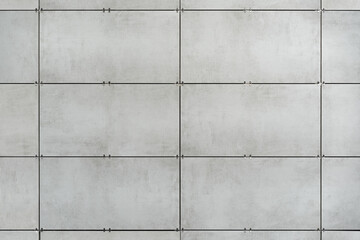 The ventilated facade of grey granite tiles creates a visually appealing facade for a modern building and offices.