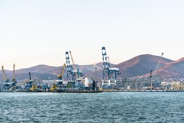 Seaport with tugboats and industrial cranes, Novorossiysk, Russia. The Black Sea. Silhouettes of the seaport