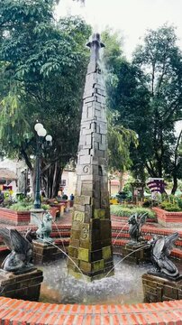 Fountain with gargoyles in Jerico on a cloudy day,  Colombia