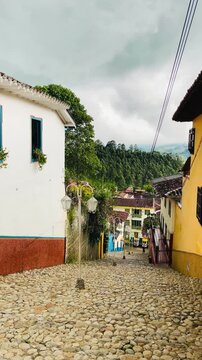 Stone steps and lanterns on a colorful colonial street in Jerico, Colombia