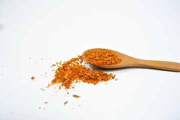 Chili powder on wooden spoon isolated on white background. Chili powder for product cover, advertisement and others
