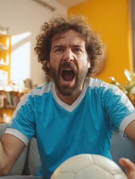 Argentina football fan screaming during match at home wearing sky blue jersey
