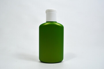 Cosmetic bottle, clean green unbranded shampoo bottle isolated on white background. Plain cosmetic bottle for product advertising
