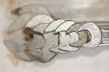 Metallic wrenches in spiral pattern on blurred background